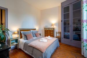 a bedroom with a bed with two towels on it at H de Surgères in Surgères