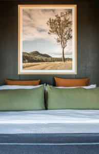 a bedroom with a bed with a tree in the background at Wander in the Scenic Rim in Wyaralong