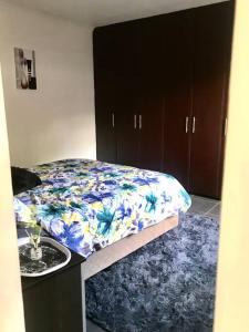 een slaapkamer met een bed met een blauw-witte deken bij Morningview Cottage - Self Catering Private Owned Rental in Durban