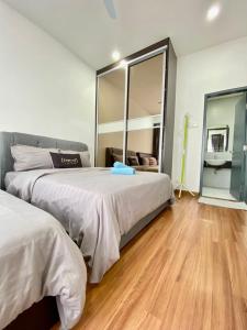 a bedroom with two beds and a large mirror at Da Men Subang Jaya USJ by Iconique in Subang Jaya