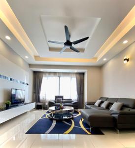 a living room with a couch and a ceiling fan at Da Men Subang Jaya USJ by Iconique in Subang Jaya