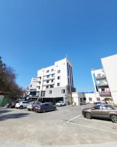 un estacionamiento con autos estacionados frente a un edificio en Hotel Gongjicheon, en Chuncheon