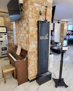 a brick wall with a piano next to a fireplace at Hotel Gongjicheon in Chuncheon