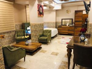 a hotel room with a bed and a table and chairs at Royal Eagle Hotel in An Najaf
