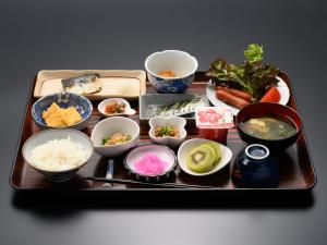 a tray with various dishes of food on it at Tabist HotelNakajima Fuji in Heigaki