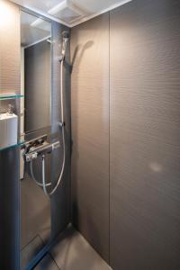 a shower in a bathroom with a glass door at SEN.RETREAT CHIKATSUYU in Tanabe