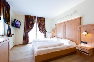 Postel nebo postele na pokoji v ubytování Hotel Touring