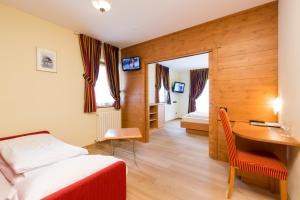 Postel nebo postele na pokoji v ubytování Hotel Touring