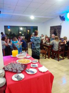 a group of people sitting at a table with food at Hotel MOONSTONE in Anuradhapura