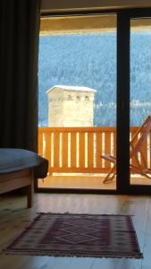 a room with a view of the ocean from a porch at Hotel Lamish in Mestia