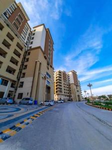 an empty street in front of some tall buildings at Serenity Corner 4 BHK in Islamabad