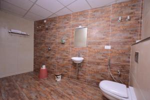 a bathroom with a sink and a toilet at RG's The 4th Residency in Trivandrum