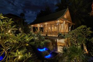 an exterior view of a house at night at Gynandha Ubud Cottage in Ubud