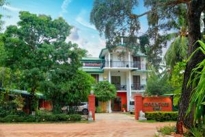 a large white house with trees in front of it at Hotel MOONSTONE in Anuradhapura