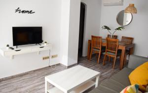 a living room with a couch and a table at Apartamento Barrosaplaya1 in Chiclana de la Frontera