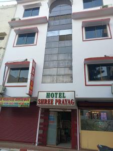 a building with a hotelire prayer sign in front of it at HOTEL SHREE PRAYAG in Nāthdwāra