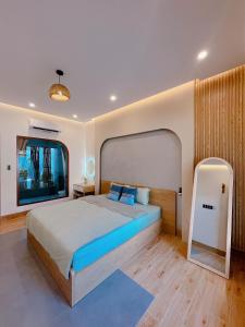 a bedroom with a large bed and a large window at Sea House Hotels and Apartments in Vung Tau