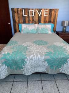 a bedroom with a bed with a wooden headboard at Esperanza Inn Guesthouse in Vieques