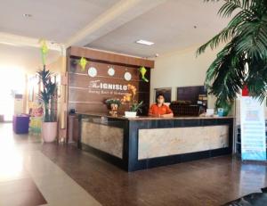 a man standing behind a counter in a restaurant at THE IGNISLO HOTEL SORONG in Sorong