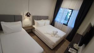 Postel nebo postele na pokoji v ubytování De Luna Hotel Sri Petaling