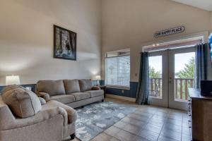 a living room with two couches and a balcony at Owl See You 3205 - Close to Dollywood and Overlooking Gatlinburg Golf Course condo in Pigeon Forge