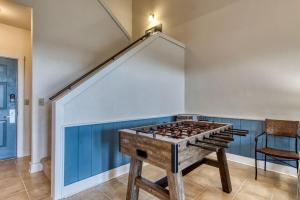 a room with a foosball table in front of a wall at Owl See You 3205 - Close to Dollywood and Overlooking Gatlinburg Golf Course condo in Pigeon Forge +28 photos
