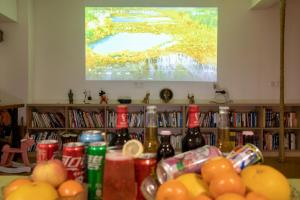 a table topped with lots of food and a television at Cheng Jin Hotel in Huangshan City