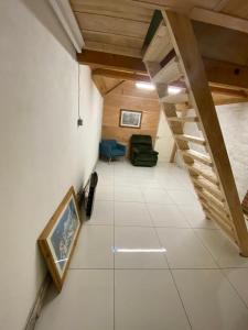 an attic room with a staircase and a living room at Parkview in Hoo