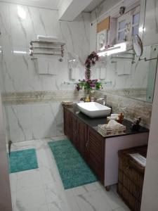 uma casa de banho com um lavatório e um chuveiro em Cherry Blossom em Nainital