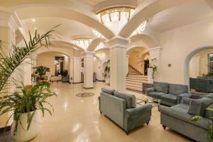 a lobby with couches and plants in a building at Jermuk Olympia Sanatorium in Jermuk