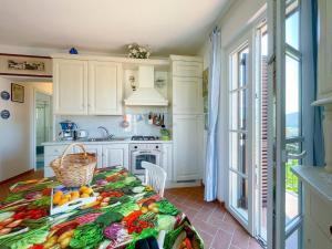 a kitchen with a table with fruits and vegetables on it at Appartamento Laura in Portoferraio