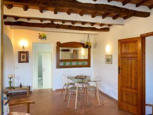 a dining room with a glass table and chairs at Appartamento Betty in Marciana