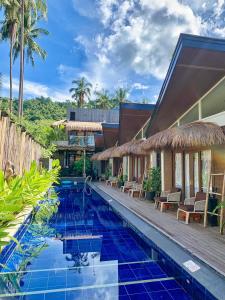 a pool at a villa with a resort at Banig Beach Resort El Nido in El Nido