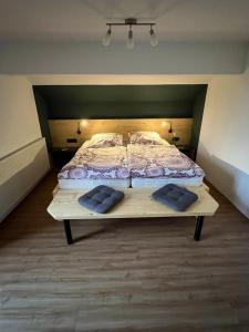 a bedroom with a bed with two pillows on it at Haus Guggemos in Hopferau