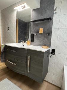 a bathroom with a sink and a mirror at Haus Guggemos in Hopferau