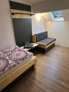 a small room with two beds and a couch at Haus Guggemos in Hopferau