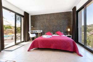 a bedroom with a large bed and large windows at Luxury Sitges Hills Villa in Olivella +25 photos