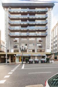 a large building with balconies on the side of a street at Le Studio. Único, acogedor y en el centro de Vigo. in Vigo