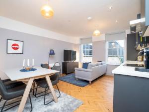 a kitchen and living room with a table and chairs at Pass the Keys Stunning 2 bed retreat in the heart of Bath in Bath