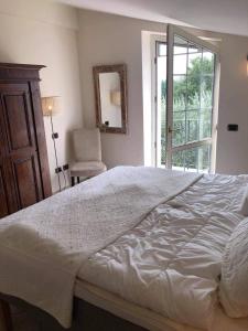 a bedroom with a large white bed and a chair at La Famiglia in Vasanello