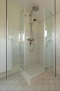 a shower with a glass enclosure in a bathroom at Villa Grace in Dalfsen
