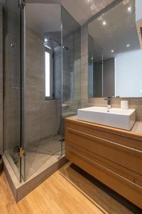 a bathroom with a sink and a shower at Phaedrus Living: Luxury Flat Vouliagmeni in Athens