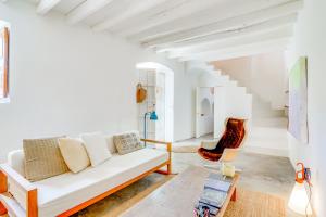 a living room with a white couch and a chair at Ses Salines Terrace Home in Ses Salines