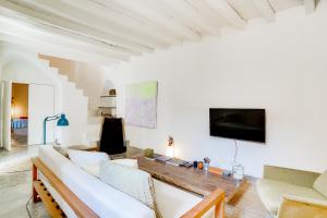 a living room with a couch and a tv at Ses Salines Terrace Home in Ses Salines