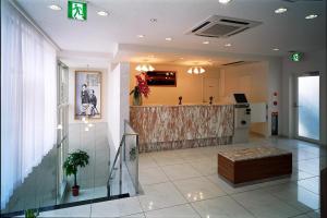 an office lobby with a counter in the middle of it at Kochi Ryoma Hotel in Kochi