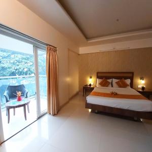 ein Schlafzimmer mit einem Bett und einem großen Fenster in der Unterkunft Quality Inn Mint in Pune + 30 Fotos