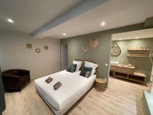a bedroom with a large white bed and a desk at Suite cosy au cœur de Vinzelles proche Mâcon Tout équipé avec salon d'extérieur in Vinzelles