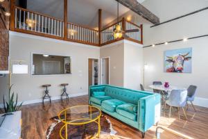 a living room with a blue couch and a table at Ultra Chic Loft sleeps 4 in Fayetteville