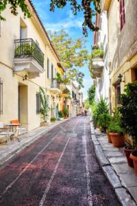 an empty street in a city with buildings at Athens Plaka Hill luxury Flat in Athens