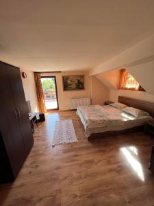 ein Schlafzimmer mit einem Bett und einem großen Fenster in der Unterkunft Casa Iris Colibita in Colibiţa